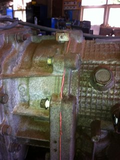 Adaptor between Transfer and gearbox:  Transfer case to be removed first to access bolt inside adapter to remove adapter from gearbox